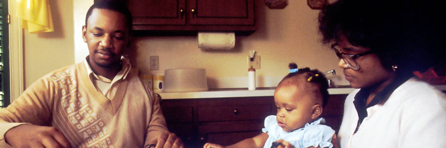 Parents calculating child support payments at a kitchen table