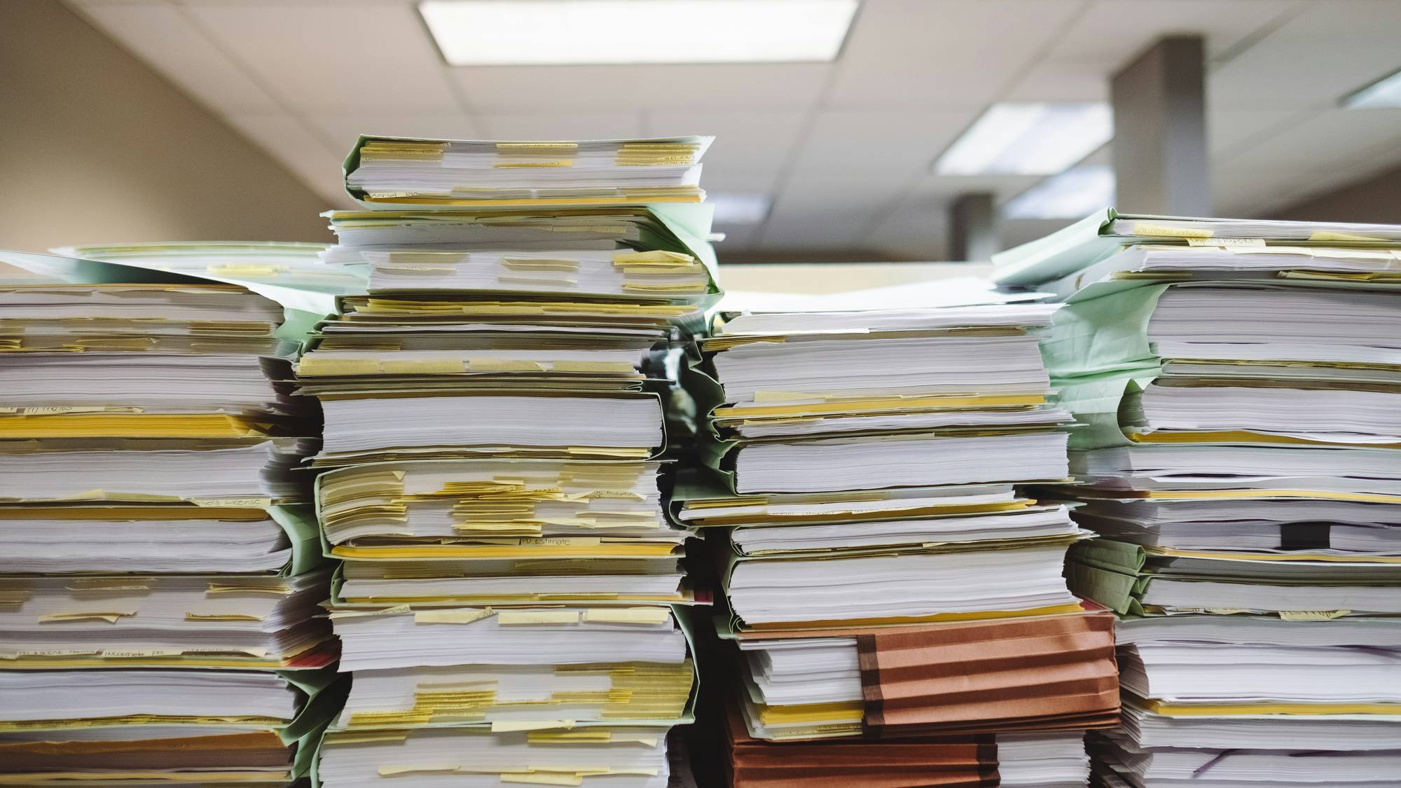 Stacks of divorce default paperwork on courthouse desk