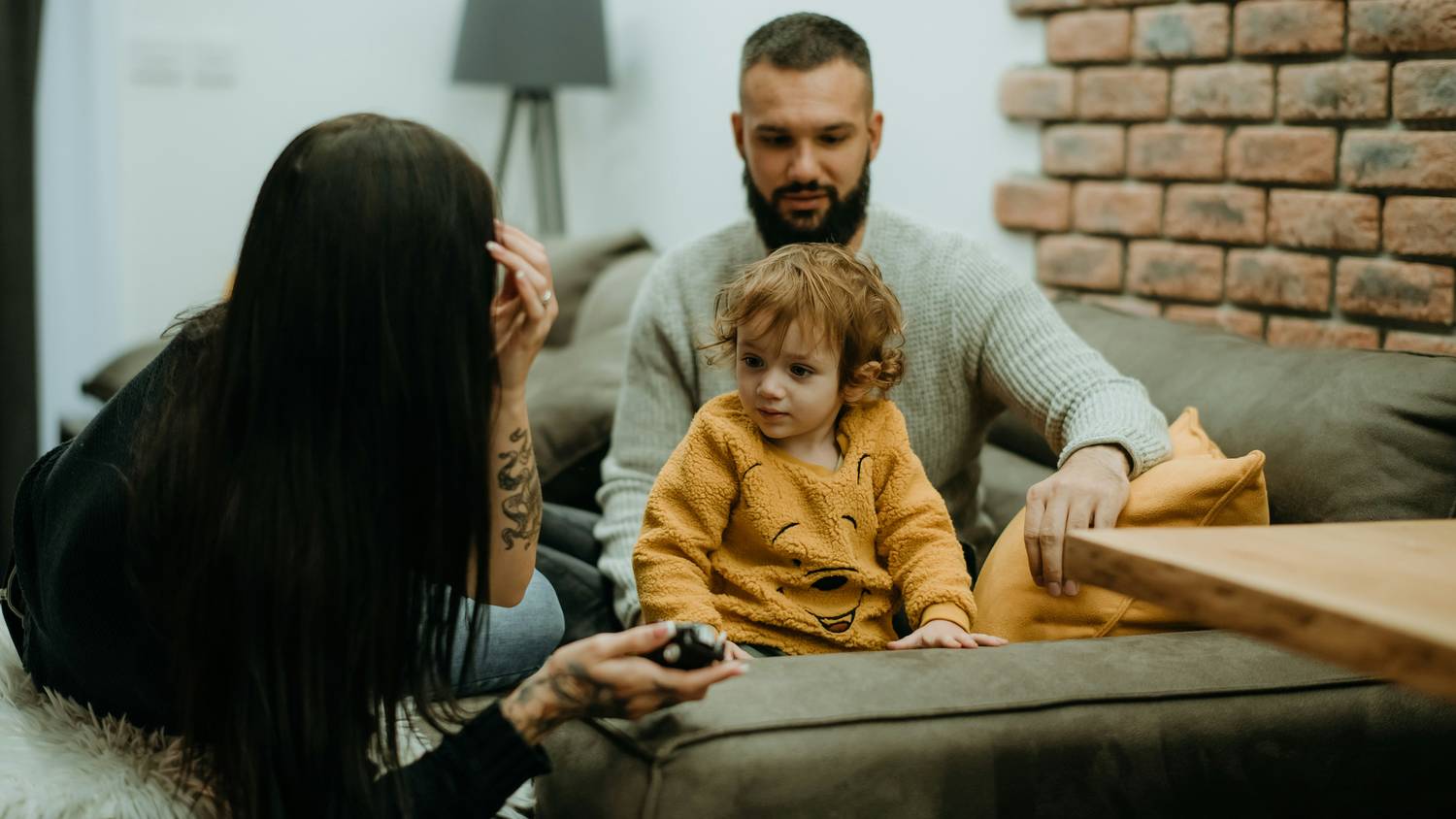 Parents reassuring their child during California divorce discussion