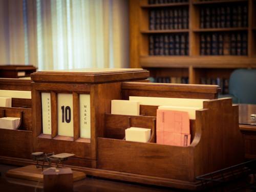 Judge’s gavel resting on support documents