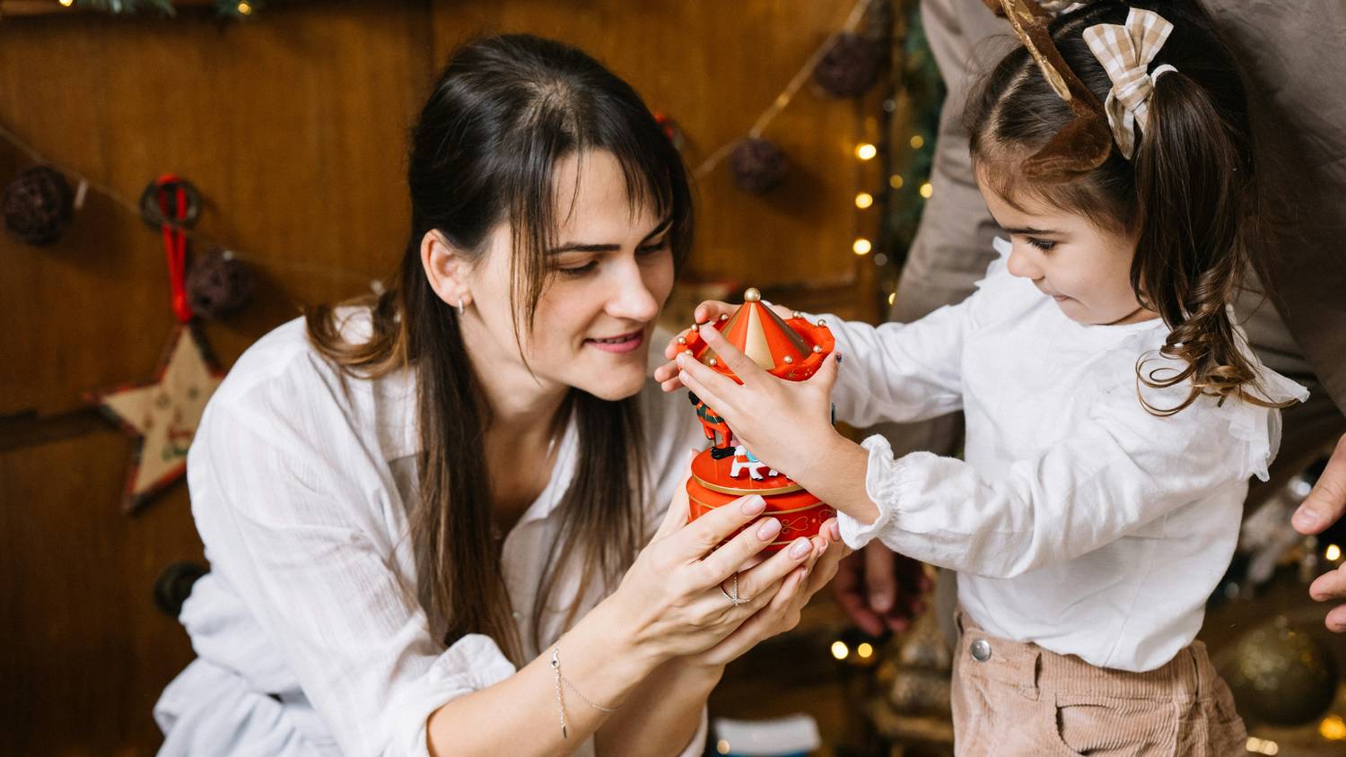 Parents exchanging gifts with child during festive holiday hand-off