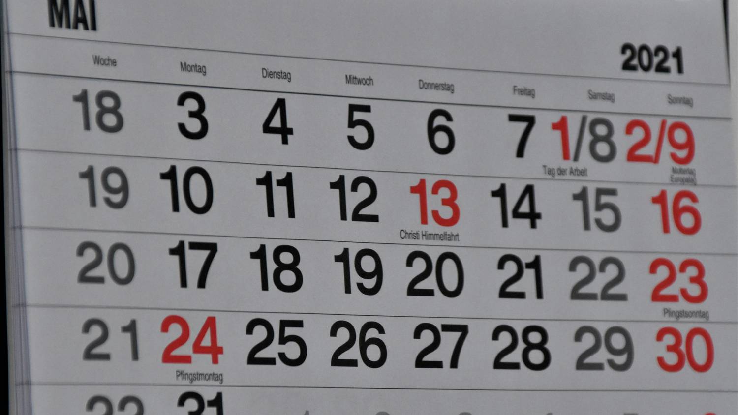 Parents using a calendar to mark holiday custody schedule