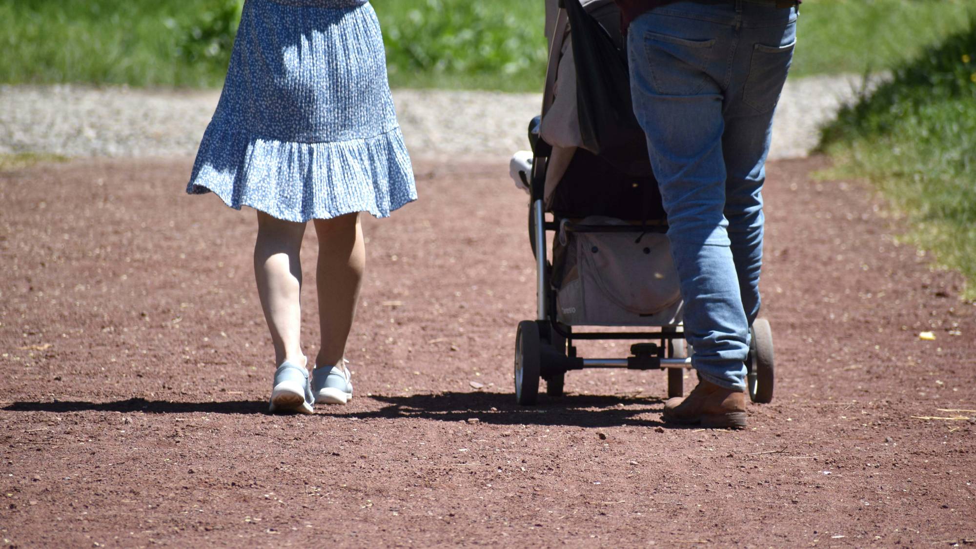 Co-parents walking together with child after California court hearing